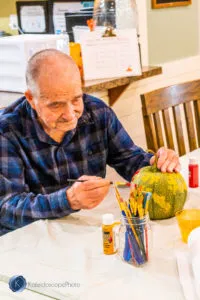 resident decorating pumpkin