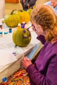 resident decorating pumpkin
