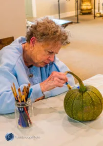 resident decorating pumpkin