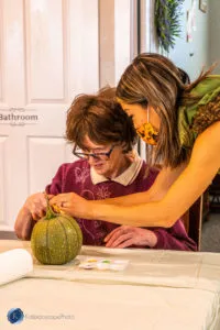 resident decorating pumpkin