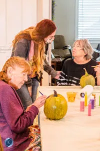 resident decorating pumpkin